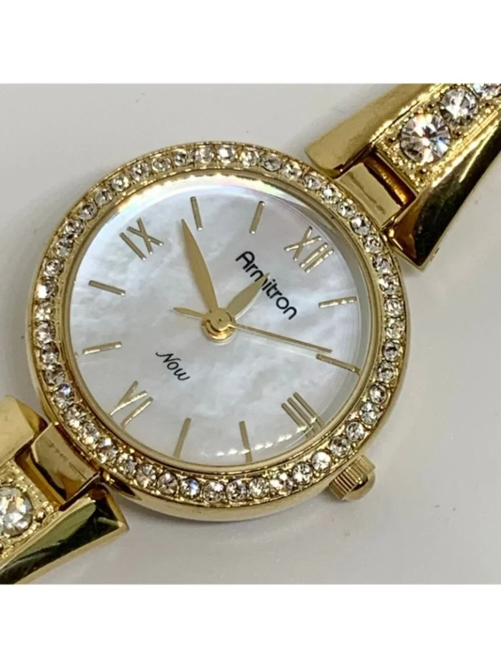Armitron women’s watch gold tone 24mm mop dial quartz rhinestones running
